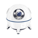 White spaceship humidifier/projector with blue accents, spherical design, and three legs. A clear window reveals a small astronaut figure with a blue visor. Graphic design.