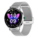 NX23 Pro Smartwatch with silver mesh band & case. Round black display features a vibrant purple butterfly wallpaper, showing 10:09, 24°C, Wed 06, and health metrics. Green crown accent. Real product photo.