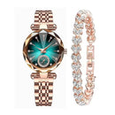 Rose gold watch with diamond-cut crystal, teal green dial, and crystal markers. Paired with a matching rose gold link bracelet featuring sparkling heart-shaped stones. Graphic design.