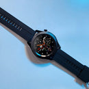 Black SmartWatch F22U featuring a textured silicone strap and round digital screen displaying 11:39, date, steps, and temperature. The bezel reads "HO SMART WATCH" with Roman numerals. Real product photo on a light blue background.
