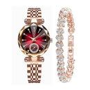 Reloj Reginald P719: Rose gold tone watch with a diamond-cut crystal, ruby red dial, stone hour markers, and link strap. Beside it, a matching rose gold tone bracelet with linked, stone-encrusted heart shapes. Studio photo.