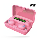 Pink F9 wireless earbuds in their open, smooth plastic charging case. Features a digital display showing 100% battery & individual earbud charge. Blue accents, 'OPEN' text. Graphic design.