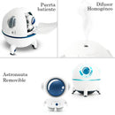 White "Spaceship Explorer" 3-in-1 humidifier shown in real product photos. Features a swing door revealing a removable astronaut, emits homogeneous vapor, and glows with blue accent lights. Smooth white plastic.
