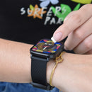 Hand taps a black square ZL99J smartwatch on a wrist, featuring a textured silicone strap and vibrant screen showing 'FRI 15'. A gold bracelet is visible; a 'SURFERS PAR' graphic tee is in the background. Real photo.