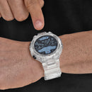 Transparent clear plastic Reloj DT5 smartwatch on a wrist, a finger pointing to its active digital screen. Displays 19:19 PM, steps, heart rate. Rugged design with GPS, Sport, Back, Select buttons. Real photo.