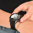 Smartwatch KC88 on a wrist, featuring a round AMOLED screen displaying 08:09, date, and activity metrics. It has a black silicone band, dark grey casing. A hand with red nails and a gold bracelet gently touches the screen. Real photo.