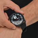 KC88 Smartwatch on a wrist. Round black AMOLED screen, sleek metal casing, silicone strap. Face shows stylized white numbers, white/red hands, 'FRI 09'. Real photo, sporty, modern design.