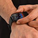 Man's arm with a black ZL99J smartwatch & ribbed strap. His finger touches the square screen displaying "17:10", "FRI 24H", and a vibrant equalizer-style pattern. Real image, highlighting its digital interface.