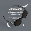 Sleek black Gafas Sol Bluetooth F07 sunglasses with dark lenses, floating on a gray background with white feathers. Text highlights "Ultra Livianas" and "30g de peso". Graphic design.
