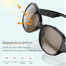 Black Bluetooth sunglasses with brown UV-protected lenses. Graphic illustrates harmful light being blocked, highlighting HD vision, UV resistance, durability, and glare elimination. Modern, sleek design.