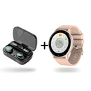 Black TWS earbuds in case with transparent lid, showing "100%", "Be Loud", "Be Proud". Beside it, a peach round smartwatch with numbers 1-12 & digital display showing "03:08", heart rate, & steps. Studio shot combo.