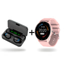 Black wireless earbuds in open charging power bank case showing '100%' battery. Next to it, a round pink smartwatch with silicone strap displaying time, date, temperature, and fitness data. Graphic on white.