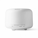 White V-M500 ultrasonic humidifier, a sleek rounded rectangle. Features front controls for LED light, timer (60, 120, 180 min, ON), and mist output (HIGH/LOW). Made of smooth plastic. Real product image on white.