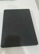 Used dark gray DELL VOSTRO 3490 laptop. Closed, its matte plastic lid with an embossed DELL logo is shown from above on a white surface.