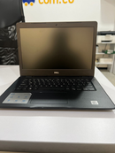 Used black Dell laptop, model Vostro 3490, open on a white desk. It has a dark matte screen with 'DELL' logo, webcam, black keyboard, and textured palm rest with an Intel Core i5 sticker. Real photo.