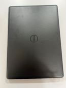 Closed used DELL VOSTRO 3490 laptop. Dark gray, textured top cover with a circular debossed DELL logo. Real product photo on a light surface.