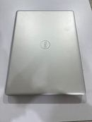Used DELL Inspiron 3493 laptop, closed, showing its silver-gray matte finish top lid with subtle texture and the embossed DELL logo. Real photo on a light background.