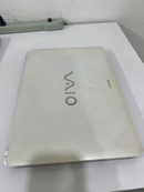 Used white SONY VAIO laptop, lid closed, with the VAIO logo and SONY text visible. Its matte surface shows scuffs and dirt. Real photo.