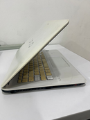 Used white Sony VAIO SVF14325CLW laptop, lid slightly open, angled side view. Shows yellowish-tan keys, VAIO logo on lid & palm rest, side ports. Real photo with visible wear/scratches on white casing.