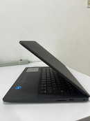 Black DELL VOSTRO 3490 laptop, slightly open, angled view showing its matte finish, full keyboard, right-side USB port, SD card slot, and an Intel Core i3 sticker on the palm rest on a white desk. Real photo.