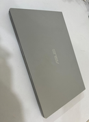 Closed gray ASUS VivoBook X415EA laptop (used), displaying its sleek metallic lid with the ASUS logo, angled on a white surface.