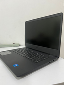 Used black DELL Vostro 3490 laptop, angled right, open on a white desk. Features a matte finish, full keyboard, black screen with 'DELL' branding, 'intel core i3' sticker, and visible SD card slot. Real photo.